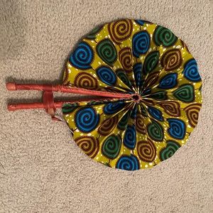 Leather and cloth fan from Ghana. Folds for easy fit in you purse or pack.